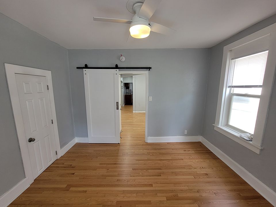 Bedroom, from porch, looking down through living room and towards kitchen