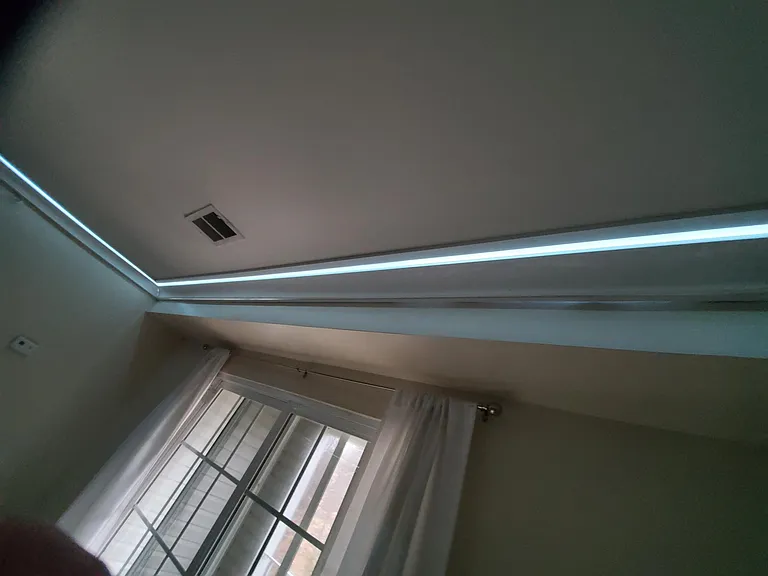 Elegant Crown Moldings with LED backlighting throughout the main level, connecting kitchen, and connecting hallway