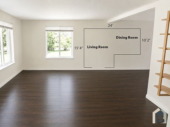 Bright welcoming living room with a view of lawn and mature evergreens