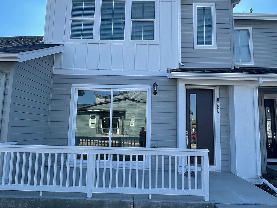 Front of the home faces west. Large concrete patio. Ring doorbell and camera.