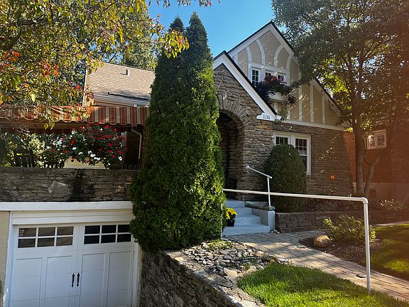 Covered deck, driveway and garage.