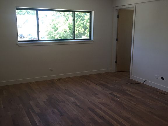 spacious living room extending from new kitchen