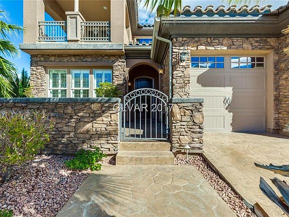 Gated courtyard entry, and stamped-concrete driveway and sidewalk