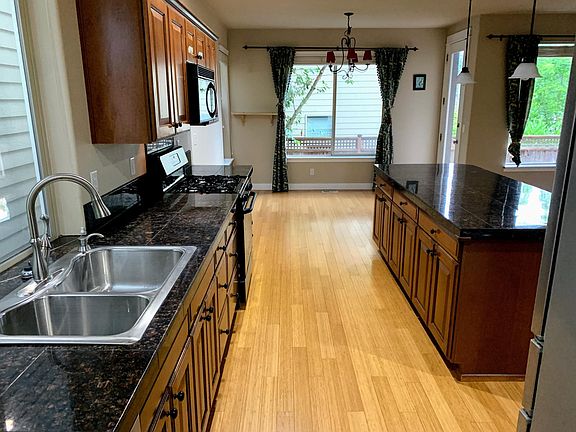 Kitchen with dual sink, gas range, and granite tile island