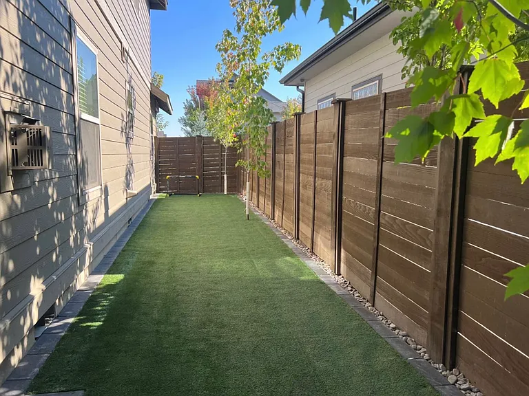 Side yard, pool on other side of fence