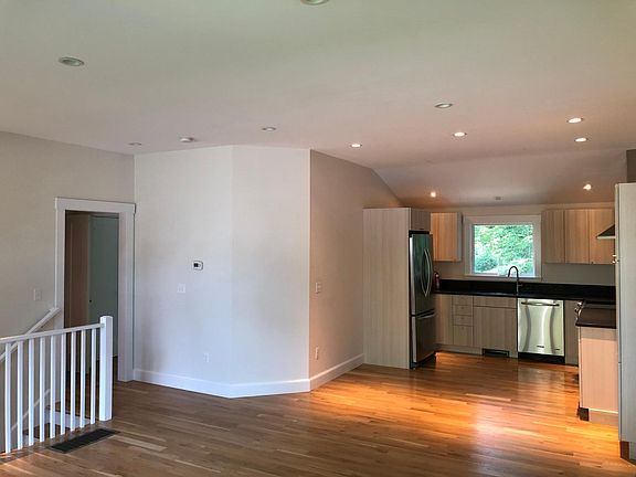 Kitchen and entrance to stairs leading to lower level.