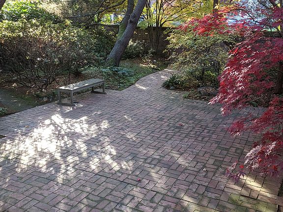 Front inner courtyard has private patio surrounded by brick wall & locked gates.
