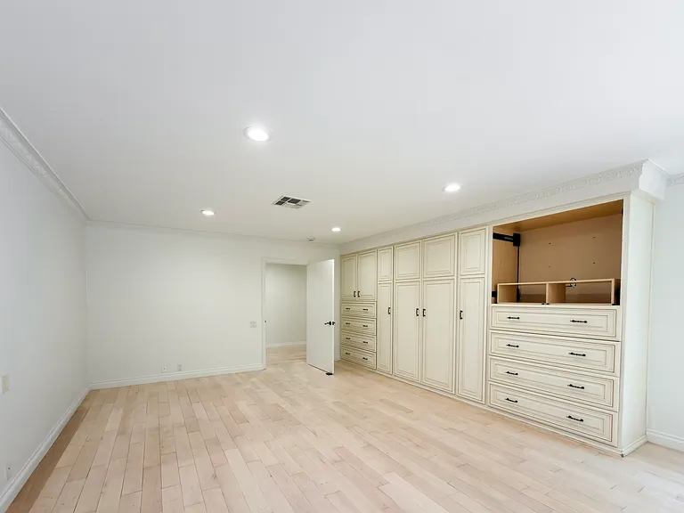 Custom built-in wardrobe with drawers and cabinetry offers exceptional storage in this Beverly Hills luxury rental bedroom at 1094 Garden Lane, 90210.