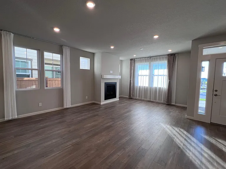 living room is spacious and comes with a fireplace and lots of sunlight