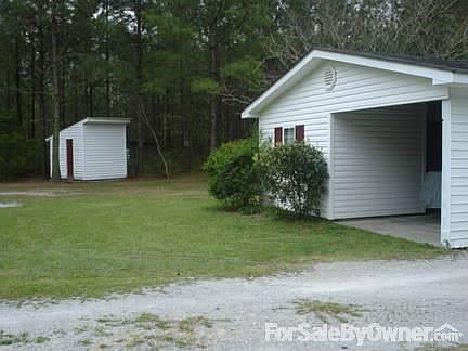 Workshop with enclosed carport