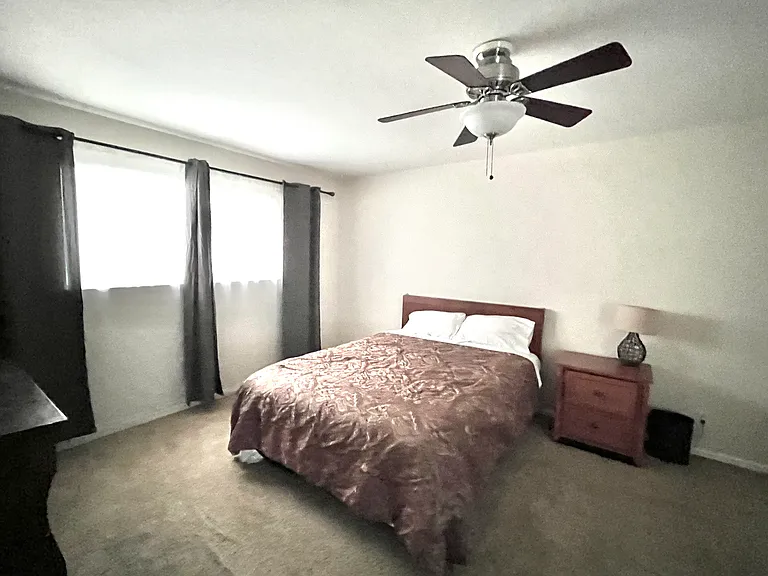 Bedroom with queen bed (sheets and comforter included), dresser, night stand, a night lamp, pictures and blackout drapes