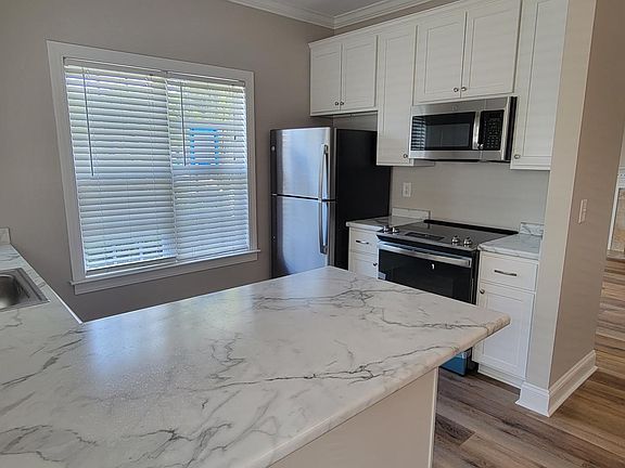 View of New Kitchen to Living Room & Gas Fireplace.