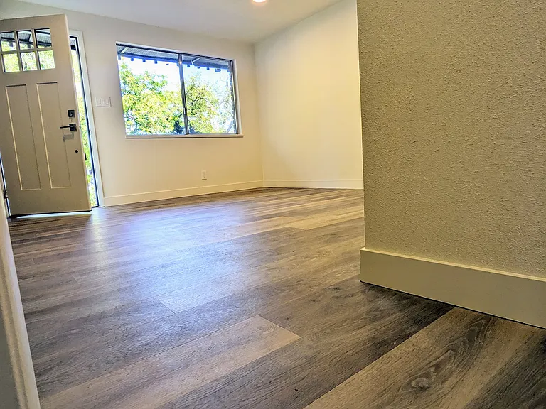 Living Room Featuring Can Lights and Brand New Flooring and Paint