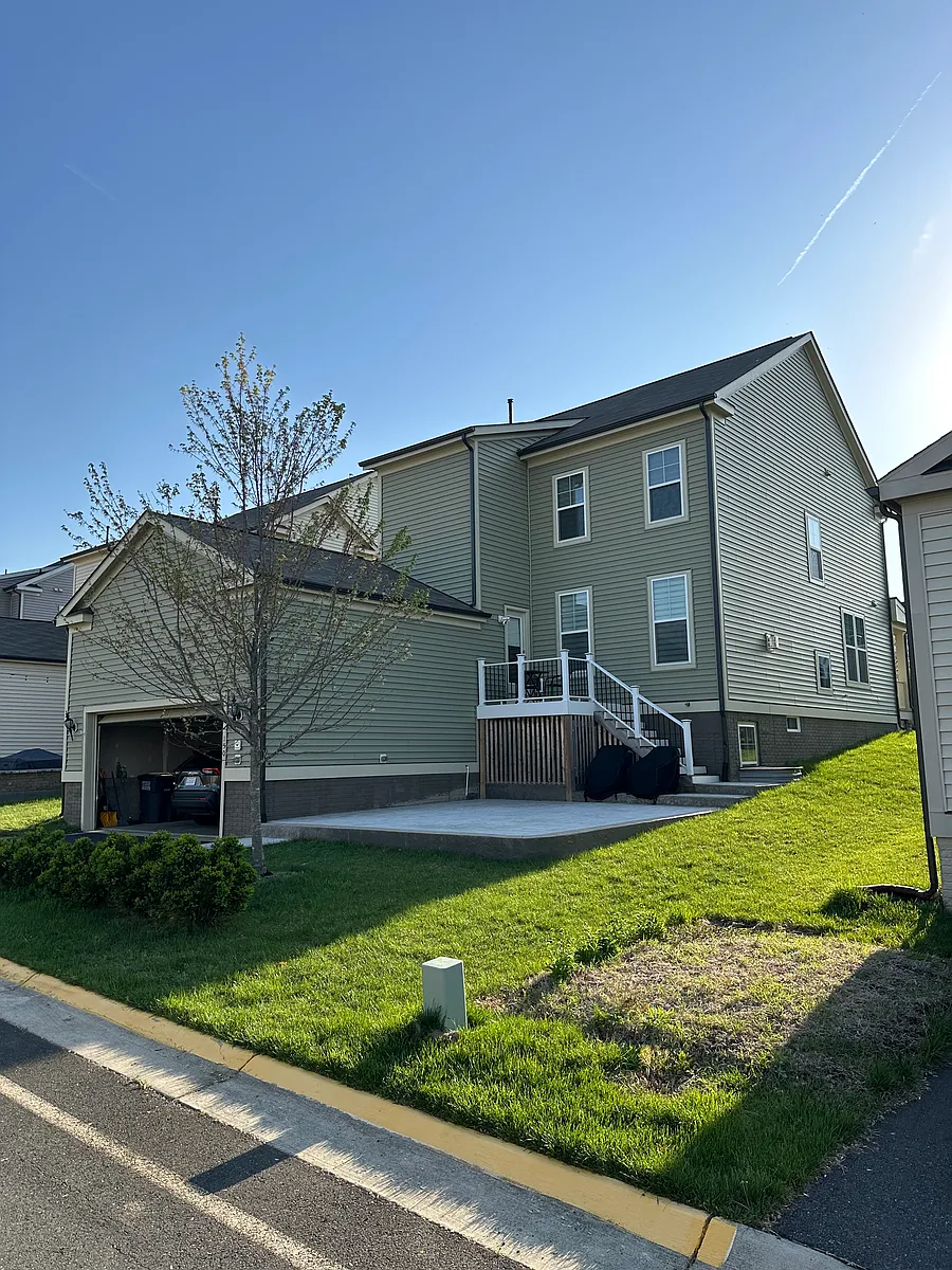 The back of the house has a deck leading to a large patio. - 150 Gardenia Dr