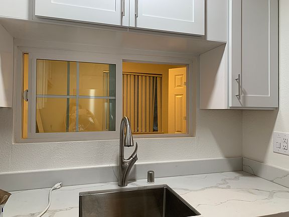 Good size window between the dinning area and kitchen. The dining area has double doors and a small closet and can be completely closed to be used as a small bedroom or office.