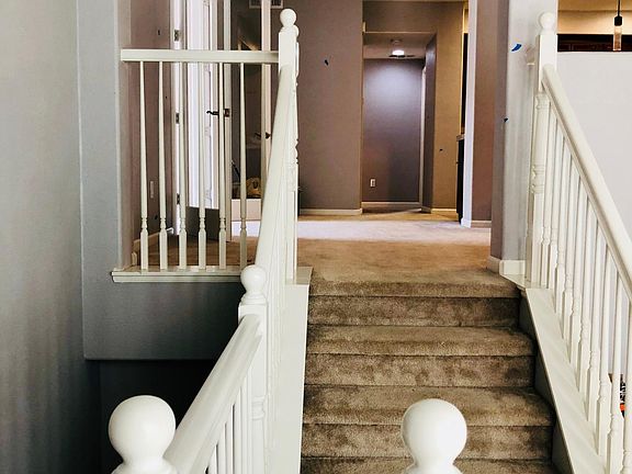 Stairs from living room towards kitchen/bedrooms