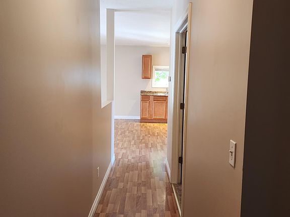 bedroom off hall with bathroom at the end of hall.