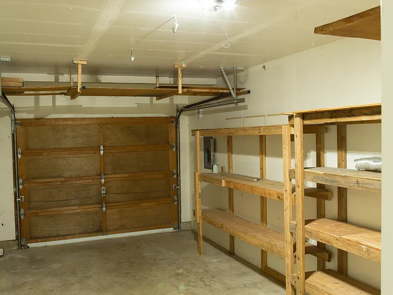 Attached 1-car garage with built-in shelving and additional storage space. Convenient off-street parking and flexible room for storage or hobbies.