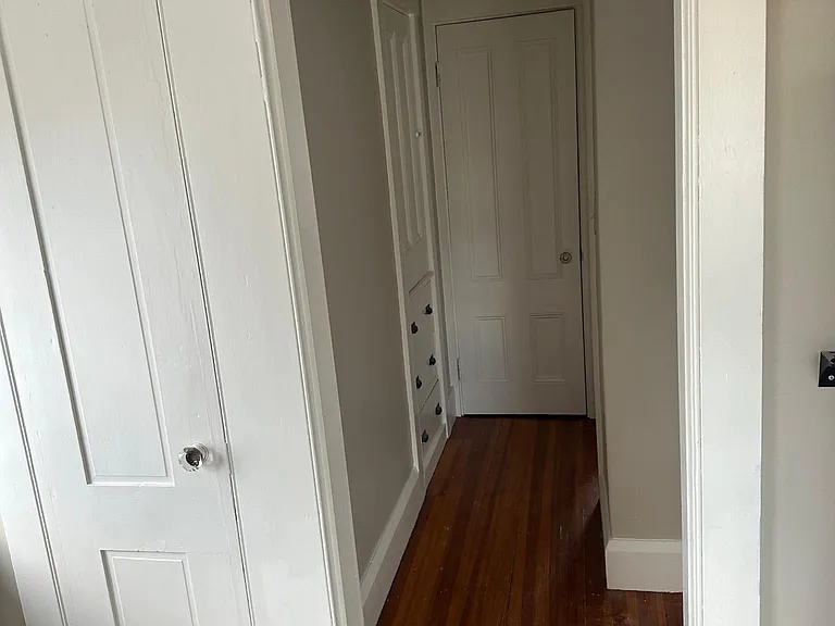 Hallway from Kitchen to large Closets on Left and Rear