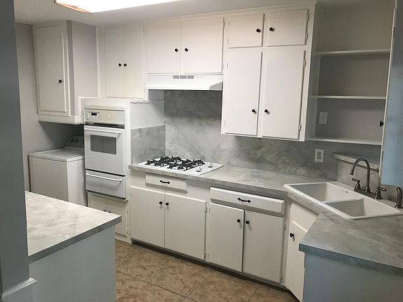 Kitchen, new countertops, newly painted cabinets and walls.
