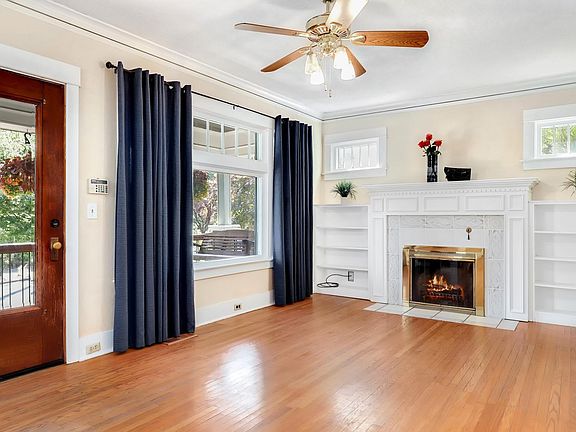 Living room with working wood fireplace and build in shelves. Main floor