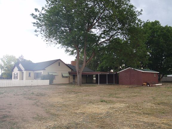Side, carport and shop.