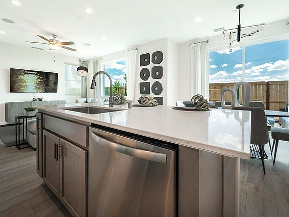 Kitchen features stainless appliances, quartz counters shaker style cabinets
