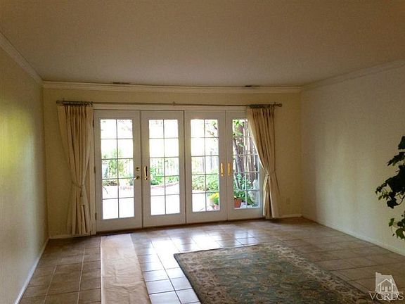 Living room with tile floors & French doors