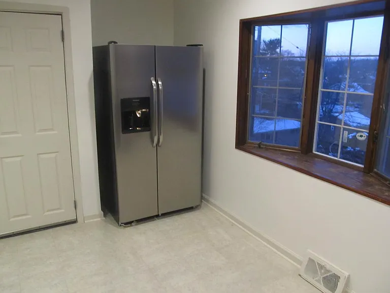 Bay window in kitchen, with large fridge