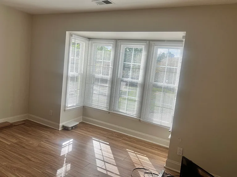 Extra large bedroom accommodate King size bad, 2 nights stands, dresser with mirror and chest.