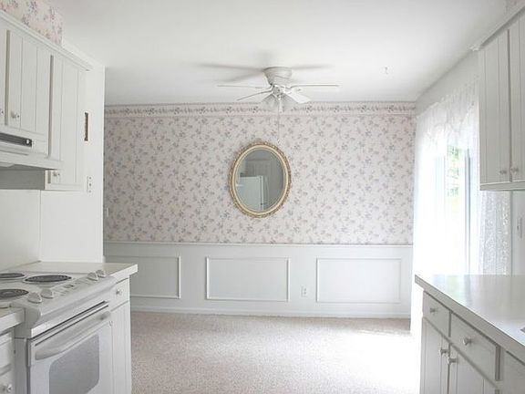 Cheerful dining area features waines coating and an updated sliding glass door with access to the deck and back yard.