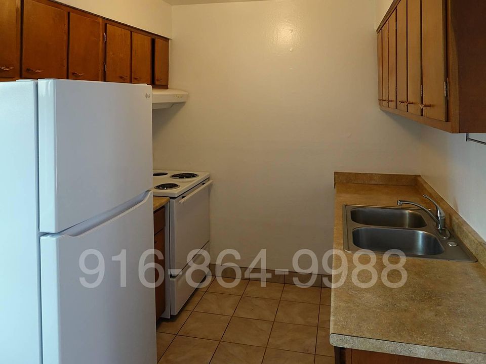Kitchen includes stove and refrigerator and plenty of storage.