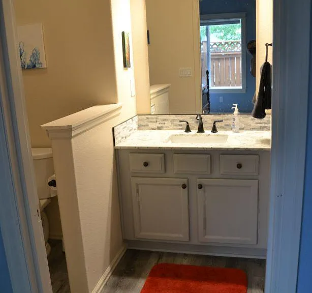 Master en-suite bathroom with shower to left and walk-in closet to right