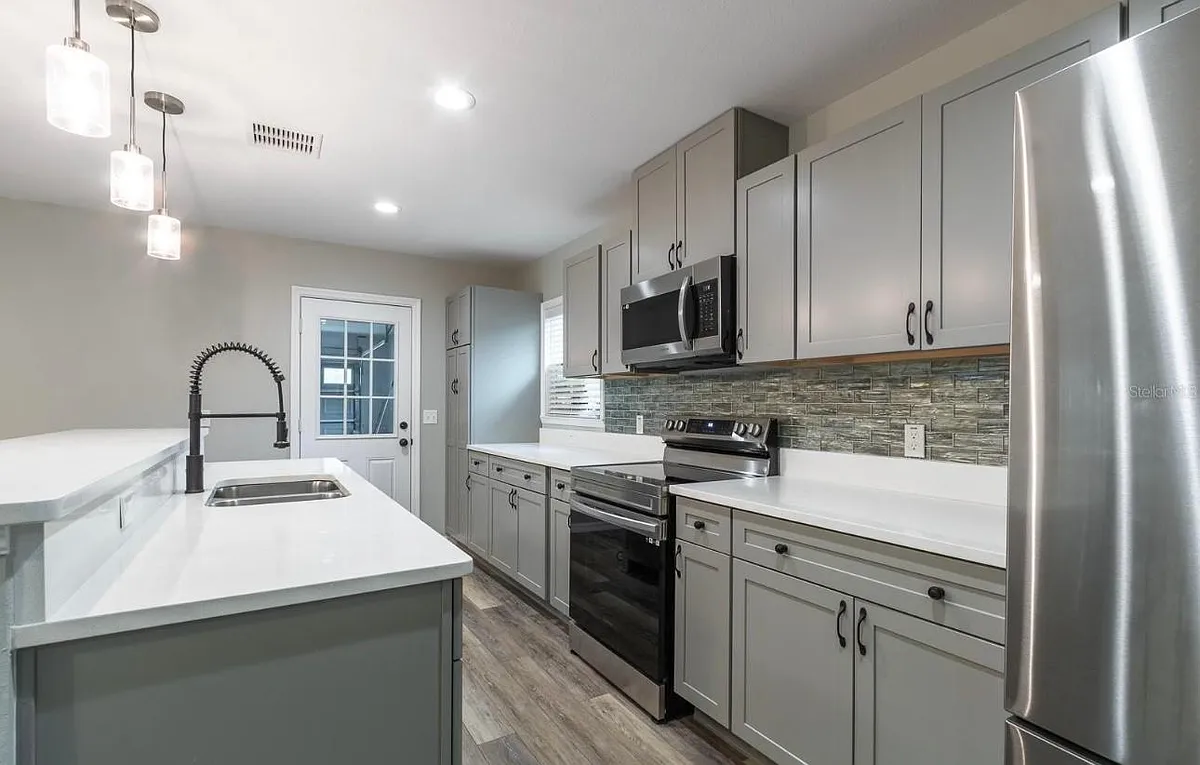 Open kitchen with stone countertops! - SW Kimberly Ln