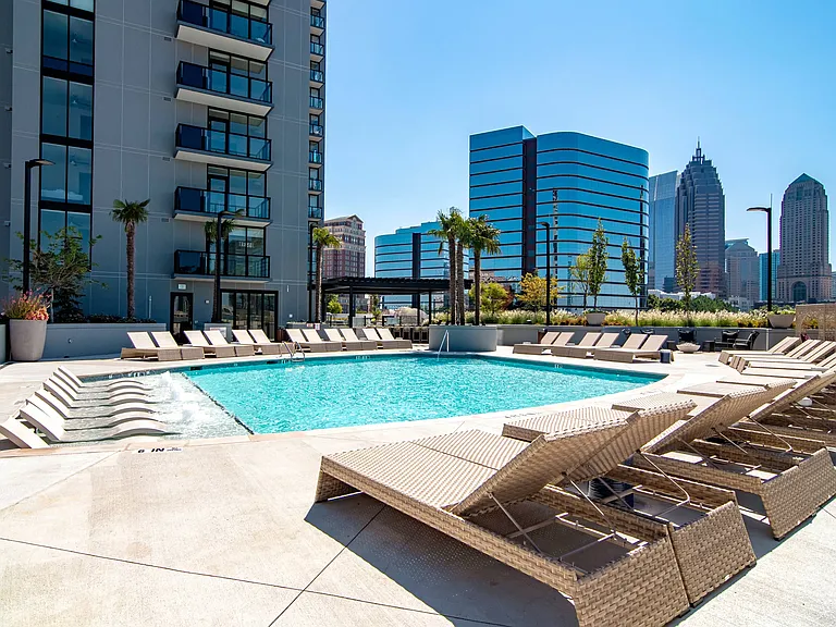 Luxe pool with chaise lounges and cabanas.