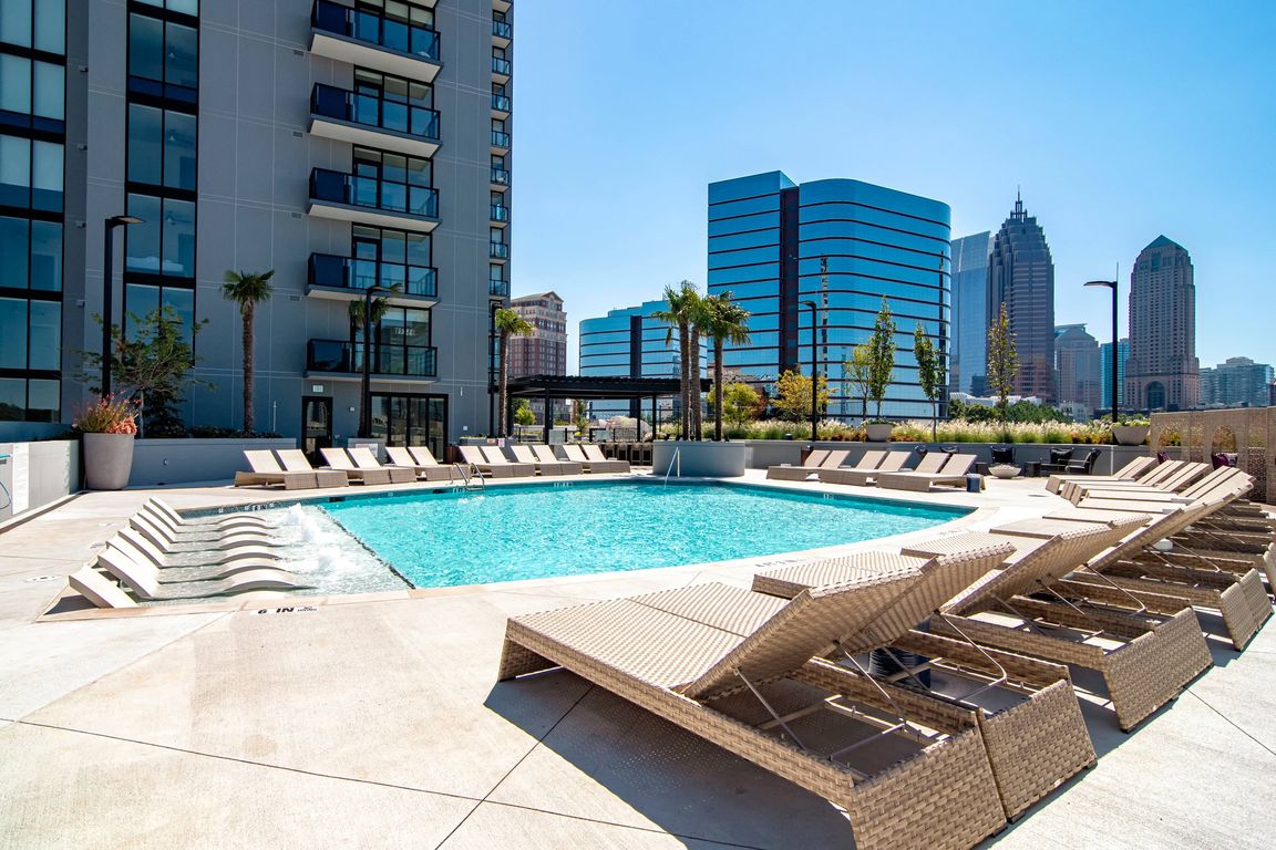 Luxe pool with chaise lounges and cabanas.