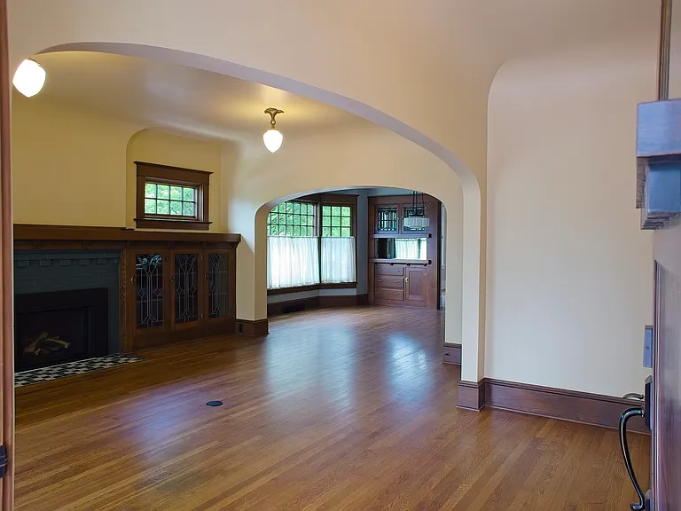 Spacious living area with original restored craftsman cabinetry.