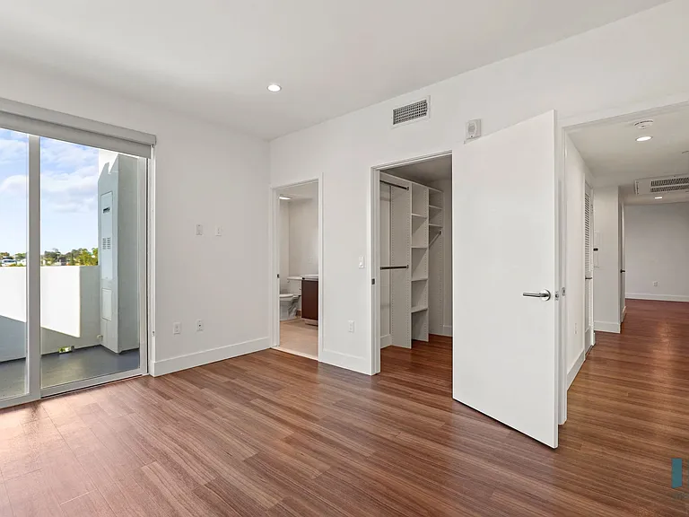 Bedroom with Bathroom, Walk-In Closet, and Patio