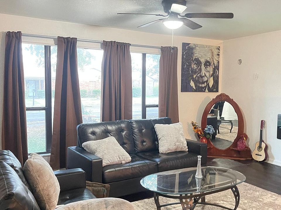 Large living room overlooking the front and open floor plan with dining area and kitchen