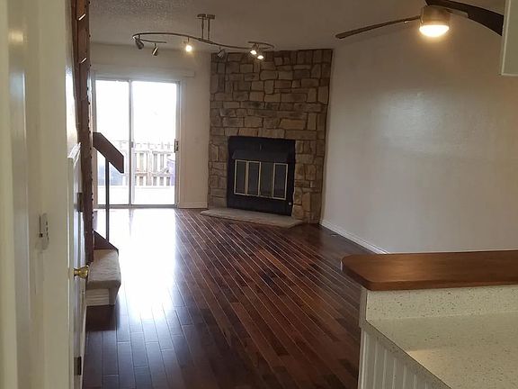 1st Floor living room, hardwood floors, wood fireplace, small deck facing west; gated.