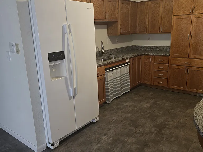 Kitchen with side by side refrigerator