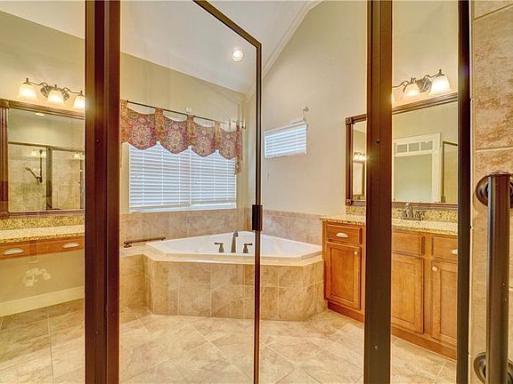 Primary bath with shower, double vanities, and tub