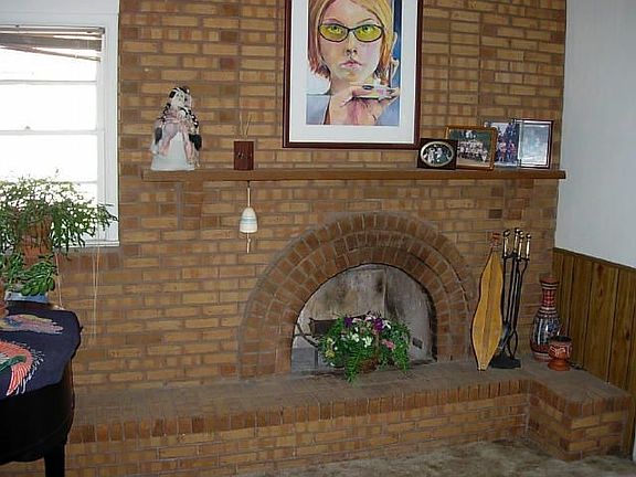 Impressive brick wood burning fireplace in family room.