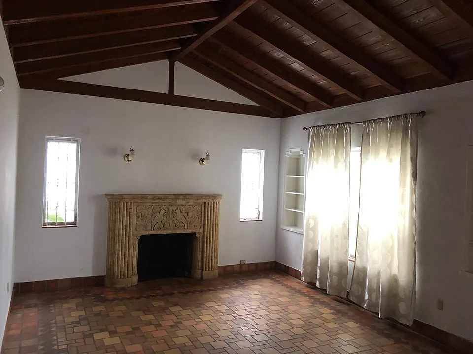 Original fireplace and wood beam ceiling