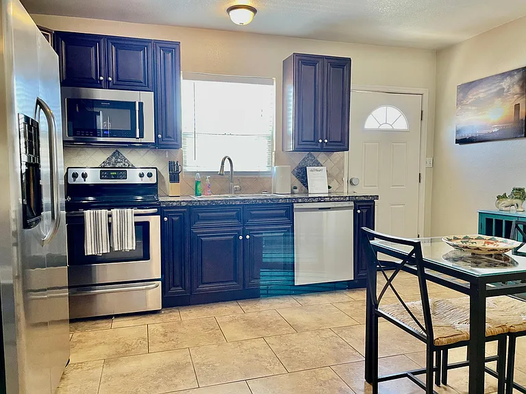 Open kitchen floor plan features full size oven/range, professional series microwave and dishwasher.