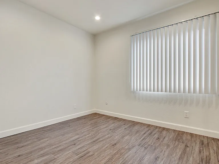 Bedroom With Vertical Blinds