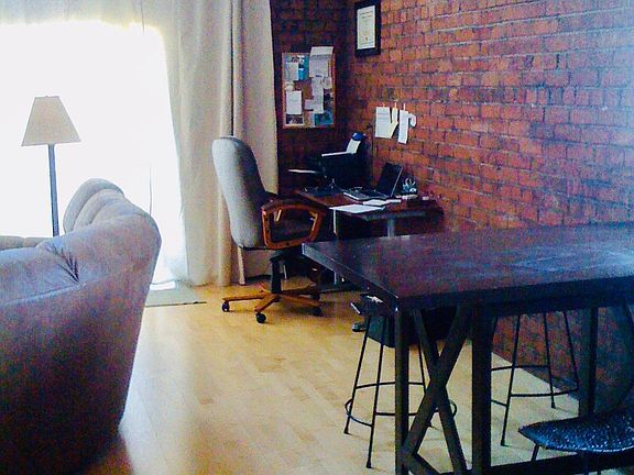 1920's red brick wall unique to this unit, charming