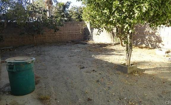 Backyard before landscape restoration. Patio wall is located on