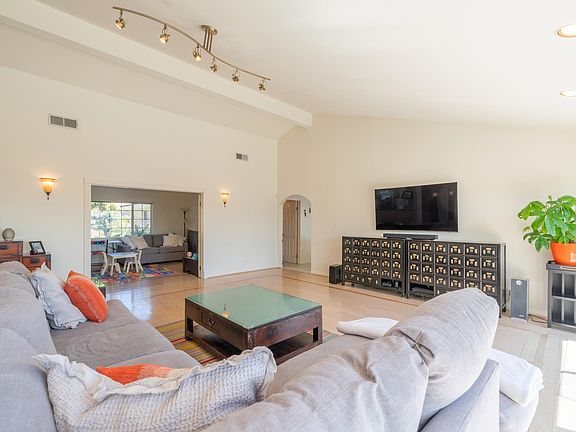 Hardwood floors and designer light fixer in the living room