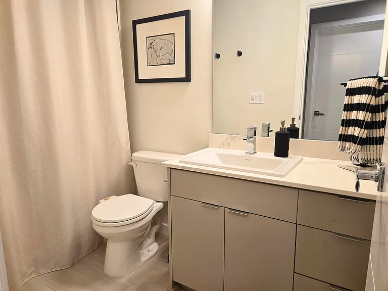 Second floor bathroom with custom tile floor, quartz counter and shower/tub